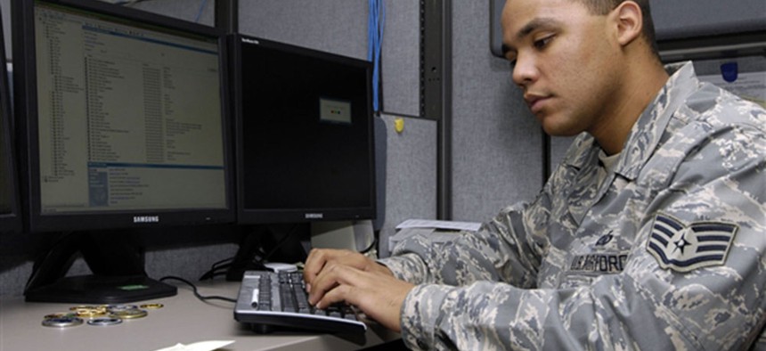 An Air Force NCO works on a computer station at Scott Air Force Base, Ill. 