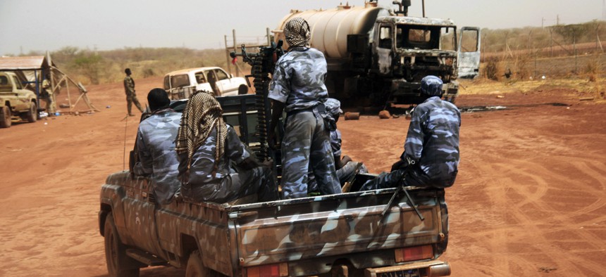 Sudanese armed forces ride a military vehicle at the border town of Heglig, Sudan, on April 24, 2012.