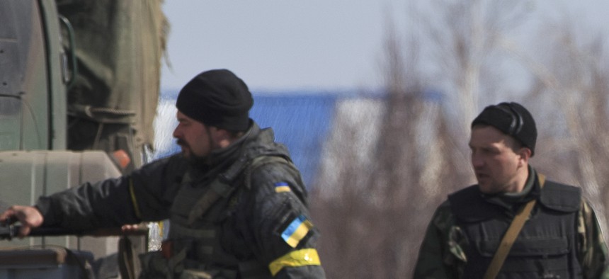 Ukrainian servicemen walk at a front line position east of the Sea of Azov port city, Mariupol, Ukraine, on March 10, 2015.