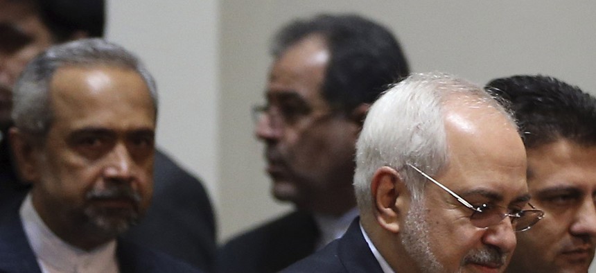 Iranian President Hassan Rouhani and foreign minister Javad Zarif arrive for a conference in Tehran, on Dec. 9, 2014.