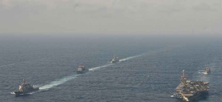 Ships from the USS George Washington Carrier Strike Group, the Japanese Maritime Self-Defense Force and the Republic of Korea Navy sail during a trilateral exercise in the East China Sea, on June 22, 2012. 