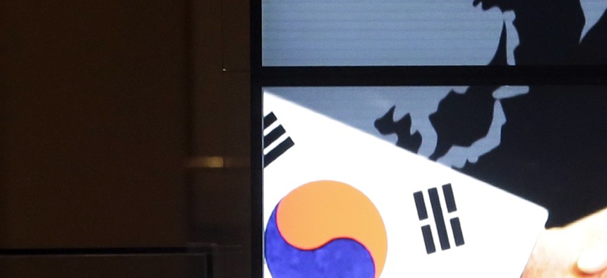 Seen here, the screen showing an image of a handshake by the U.S. and South Korean flags, on Jan. 14, 2015.