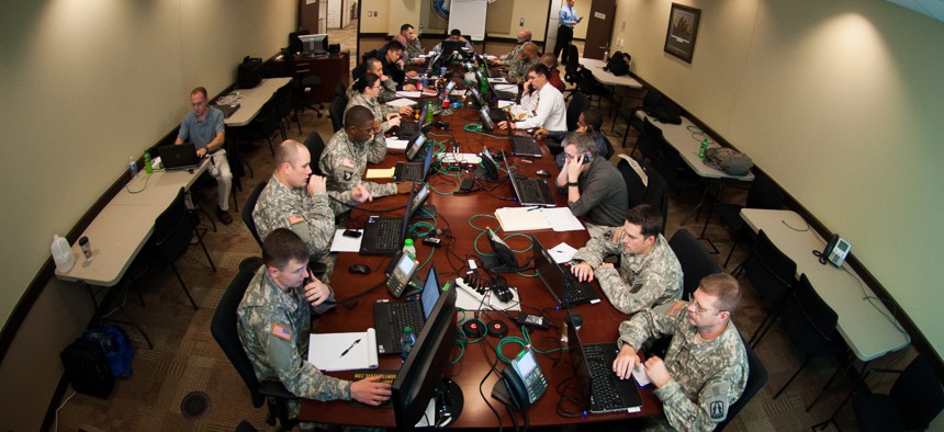 Army Reserve computer tech support experts answer calls during the Enterprise Email Migration at the U.S. Army Forces Command and U.S Army Reserve Command headquarters, Jan. 14, 2013.