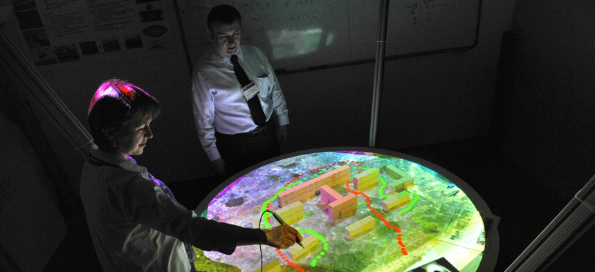 A research associate professor at the Naval Postgraduate School demonstrates the virtual sand table for urban warfare operations training rehearsals at Monterey, Calif., July 22, 2009.