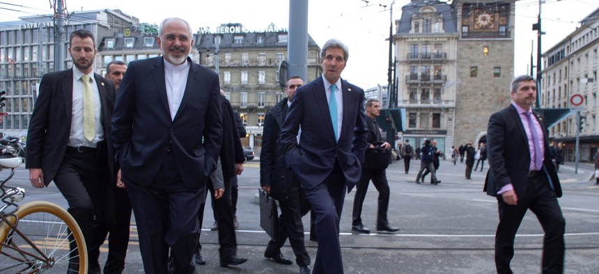U.S. Secretary of State John Kerry and Iranian Foreign Minister Javad Zarif cross a street while taking a walk in Geneva, Switzerland, on January 14, 2015.