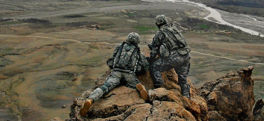 1st Lt. Jared Tomberlin (left) from the 4th Infantry Regiment, gets a first hand view of his new area of responsibility from his predecessor on top of a ridge near Forward Operation Base Lane in the Zabul Province of Afghanistan.
