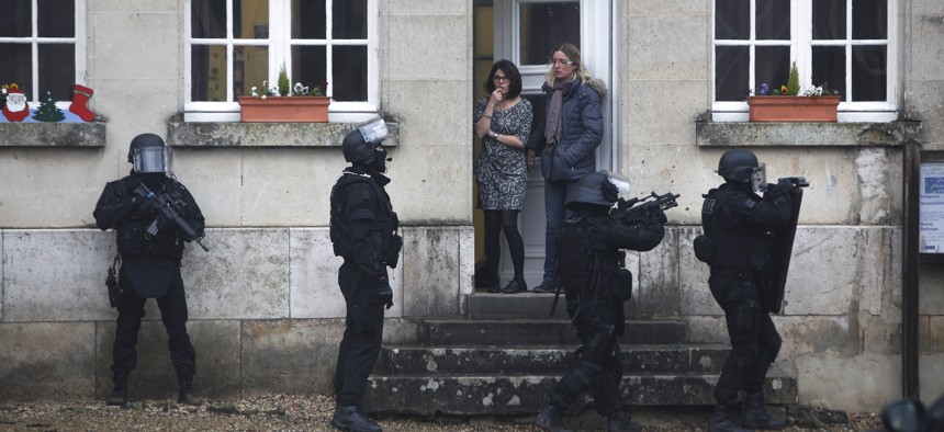  In this Jan.8, 2015 file photo, French police officers patrol in Longpont, north of Paris, France, Thursday, Jan. 8, 2015 in the search for the two suspects in the Charlie Hebdo killing.