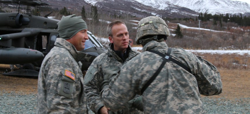 Under Secretary of the Army Brad Carson, along with Maj. Gen. Michael H. Shields, commanding general of U.S Army Alaska, arrive at Black Rapids Training Site, Nov. 18, 2014.