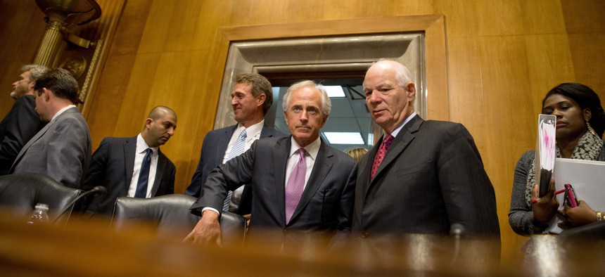 Senate Foreign Relations Committee Chairman Sen. Bob Corker, R-Tenn., center, speaks with the committee's ranking member Sen. Ben Cardin, D-Md., on Capitol Hill in Washington, Tuesday, April 14, 2015.