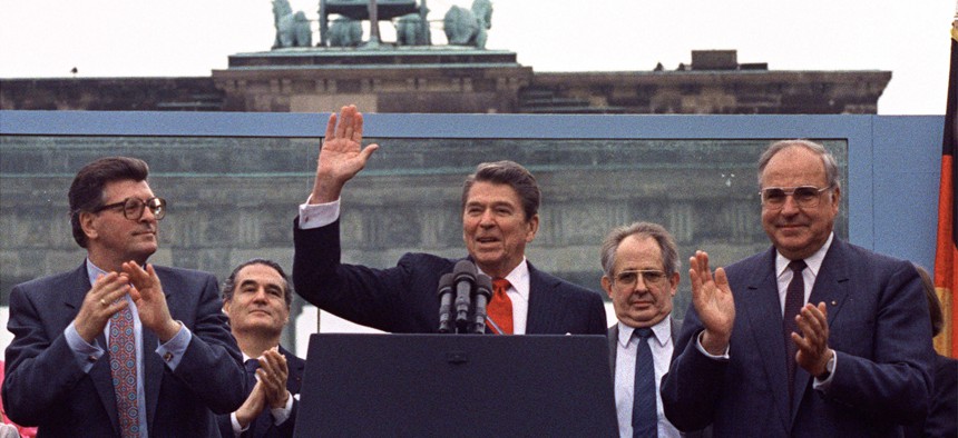 In this June 12, 1987 file picture, U.S. President Ronald Reagan acknowledges the applause after speaking to an audience in front of the Brandenburg Gate in Berlin. 