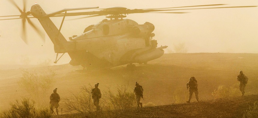 Marines with 1st Battalion, 5th Marine Regiment, participate in a heavy helo raid during Weapons and Tactics Instructor Course 2-15 at K-9 Village, Yuma Proving Grounds, Arizona, April 8, 2015. 