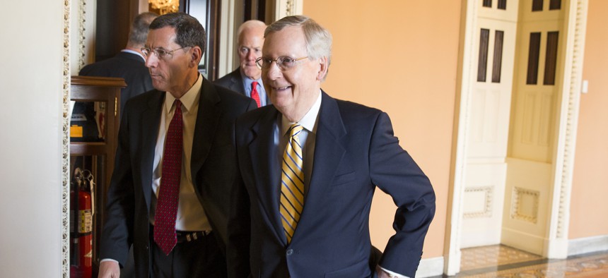 Senate Majority Leader Mitch McConnell, R- Ky., right, walks with Sen. John Barrasso, R-Wyo., left, and Senate Majority Whip John Cornyn of Texas, center, to a news conference on Capitol Hill in Washington, Tuesday, April 21, 2015.