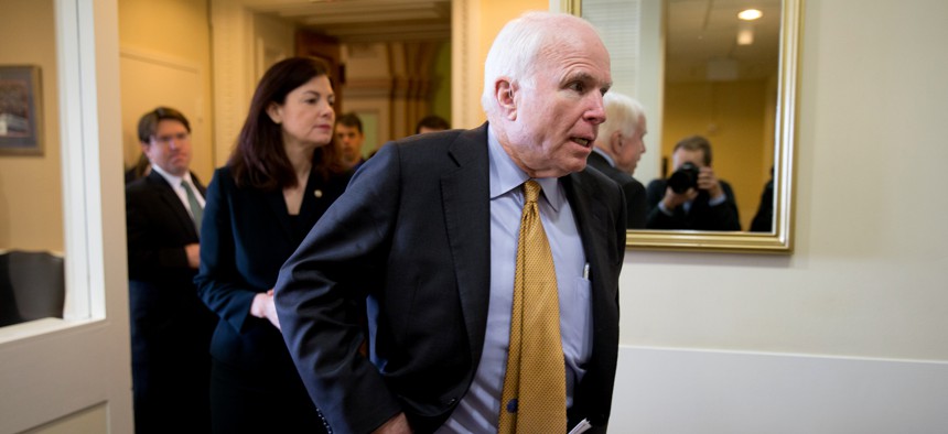 Senate Armed Services Committee Chairman Sen. John McCain, R-Ariz., right, followed by committee member Sen. Kelly Ayotte, R-N.H., arrives for a news conference on Capitol Hill in Washington, Thursday, March 26, 2015.