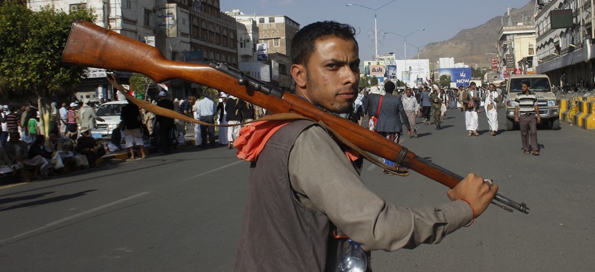A Houthi Shiite rebel carries his weapon as he joins others to protest against Saudi-led airstrikes, during a rally in Sanaa, Yemen, Wednesday, April 1, 2015.