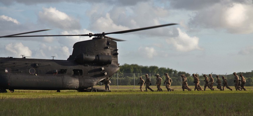 Army Rangers of 1st Battalion, 75th Ranger Regiment, prepare to enter an MH-47 helicopter to execute fast rope training at Hunter Army Airfield, Ga. June 2, 2014.