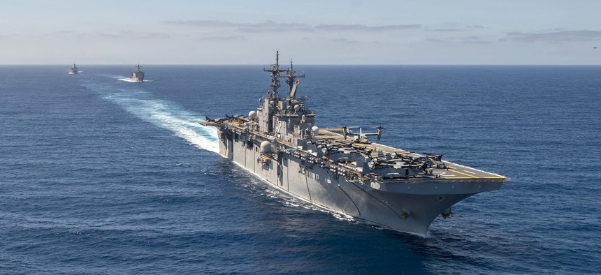 The Wasp-class amphibious assault ship USS Essex (LHD 2), front, the Whidbey Island-class amphibious dock landing ship USS Rushmore (LSD 47) and the San Antonio-class amphibious transport dock ship USS Anchorage conduct a simulated strait transit.
