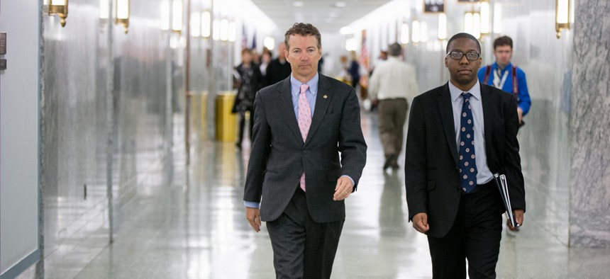 Republican Presidential candidate Sen. Rand Paul, R-Ky., center, walks on Capitol Hill in Washington, Wednesday, April 15, 2015.