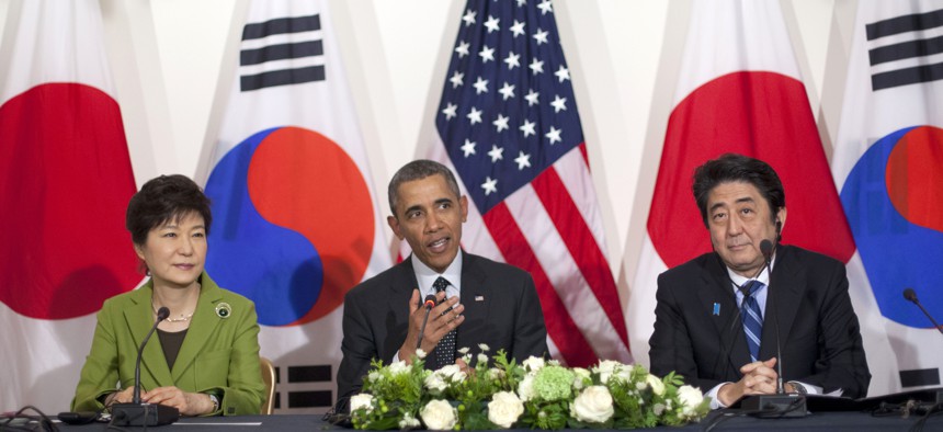 President Barack Obama meets with Japanese Prime Minister Shinzo Abe, right, and South Korean President Park Geun-hye, Tuesday, March 25, 2014.