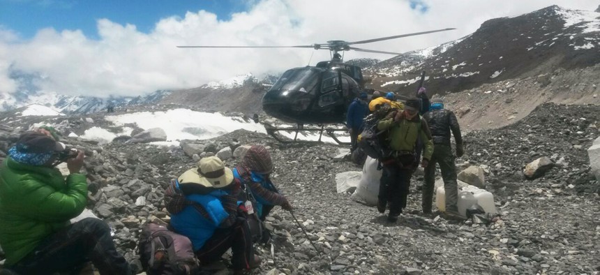 A rescue chopper lands carrying people from higher camps to Everest Base Camp, Nepal, Monday, April 27, 2015. 