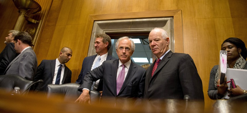 In tbis April 14, 2015 file photo, Senate Foreign Relations Committee Chairman Sen. Bob Corker, R-Tenn., center, speaks with the committee's ranking member Sen. Ben Cardin, D-Md., on Capitol Hill in Washington. 