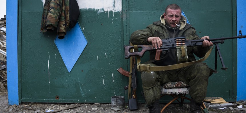 Ukrainian army soldiers perform a military exercise at a training ground outside Zhitomir, Ukraine, Friday, March 6, 2015.In this Thursday March 12, 2015 file photo, a pro-Russian rebel rests at the frontline in a village not far from Luhasnk.