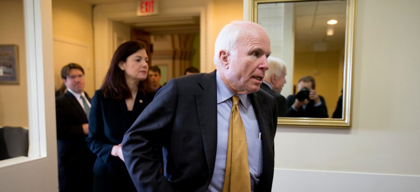 Senate Armed Services Committee Chairman Sen. John McCain, R-Ariz., right, followed by committee member Sen. Kelly Ayotte, R-N.H., arrives for a news conference on Capitol Hill in Washington, late March, 2015.