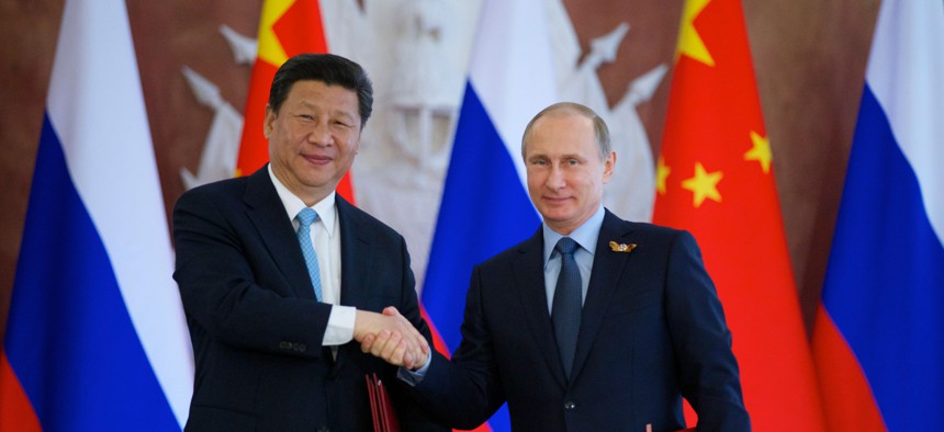 Russian President Vladimir Putin, right, and Chinese President Xi Jinping shake hands at the signing ceremony in the Kremlin in Moscow, Friday, May 8, 2015. 
