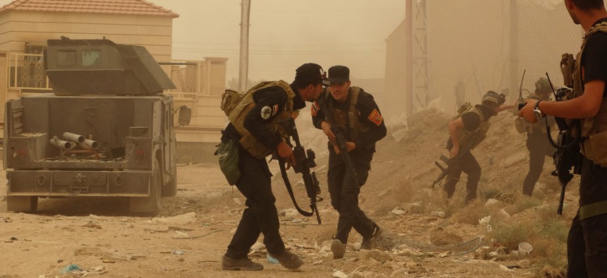 Security forces defend their headquarters against attacks by Islamic State extremists during sand storm in the eastern part of Ramadi, the capital of Anbar province, 115 kilometers (70 miles) west of Baghdad, Iraq, Thursday, May 14, 2015.