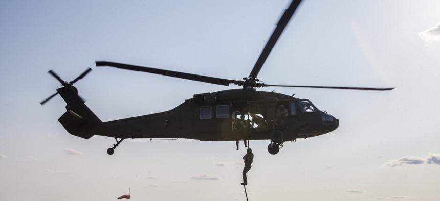 Special operations airmen repel from an Army National Guard Blackhawk helicopter while training in New Jersey. 