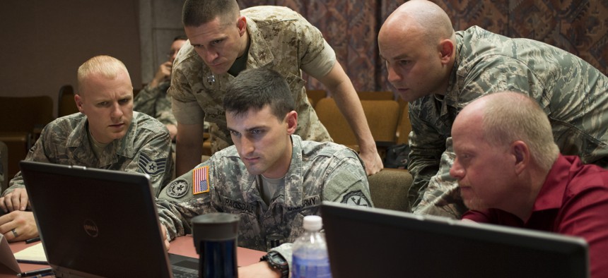 A Navy commander works with teammates at the U.S. Army's Cyber Center of Excellence at Fort Gordon, Georgia. 