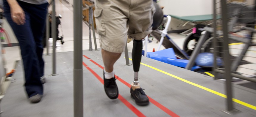 A Vietnam War veteran tries out a new prosthetic leg at the Walter Reed Army Medical Center. 