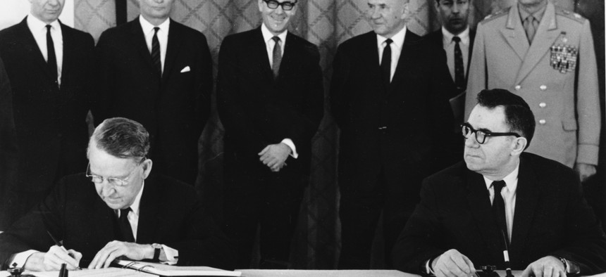 In this July 1, 1968 file photo, U.S. Ambassador Llewellyn Thompson, left, signs the Non-Proliferation Treaty alongside Soviet Foreign Minister Andrei Gromyko. 