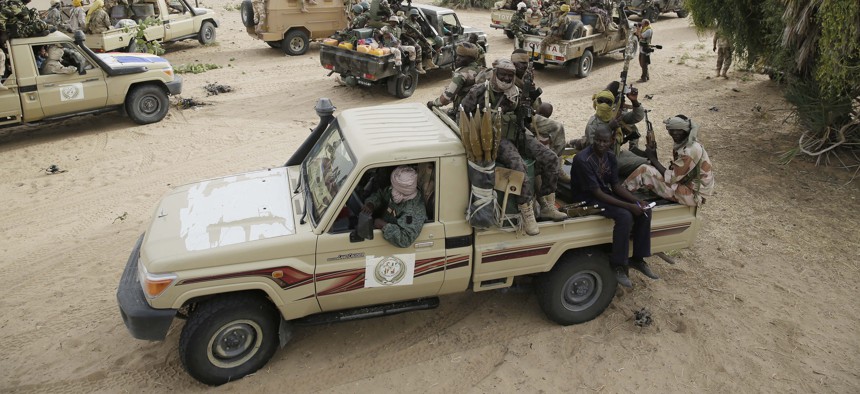 Chadian soldiers escorting a group of journalists ride on trucks and pickups in the city of Damasak, Nigeria, Wednesday March 18, 2015.