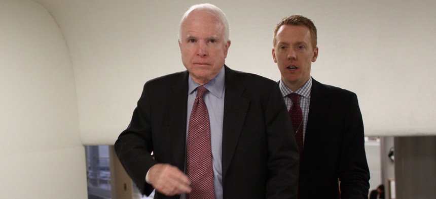 Sen. John McCain, R-Ariz., and a staff member walk on Capitol Hill in Washington, Wednesday, Feb. 25, 2015.