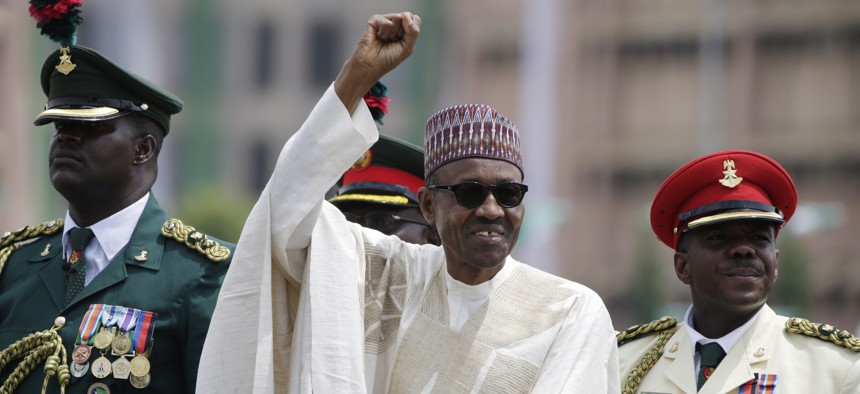 New Nigerian President, Muhammadu Buhari, salutes his supporters during his Inauguration in Abuja, Nigeria, Friday, May 29, 2015. 