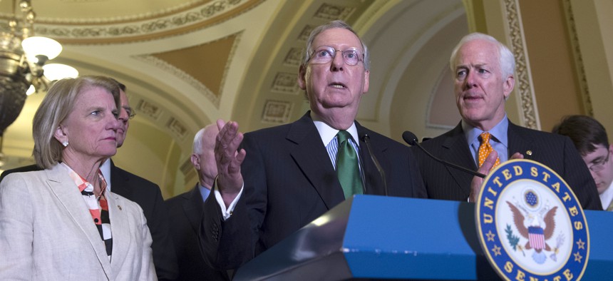 enate Majority Leader Mitch McConnell of Ky. , flanked by Sen. Shelley Moore Capito, R-W.Va., left, and Senate Majority Whip John Cornyn of Texas, speaks during a news conference on Capitol Hill on June 9, 2015.