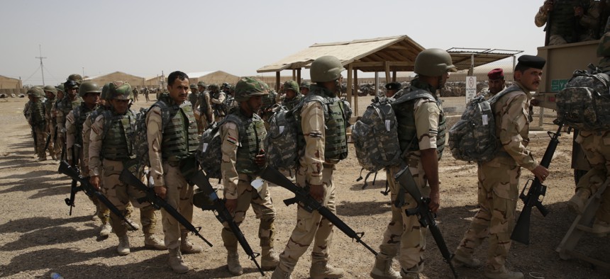 Soldiers from the 76th Iraqi Army Brigade prepare to load a truck with their new M16A2 rifles and military equipment at the Taji Military Complex, Iraq, May 24, 2015.