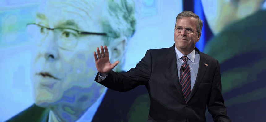 Former Florida Gov. Jeb Bush waves while walking on the stage to speak at Rick Scott's Economic Growth Summit in Lake Buena Vista, Fla., Tuesday, June 2, 2015. 