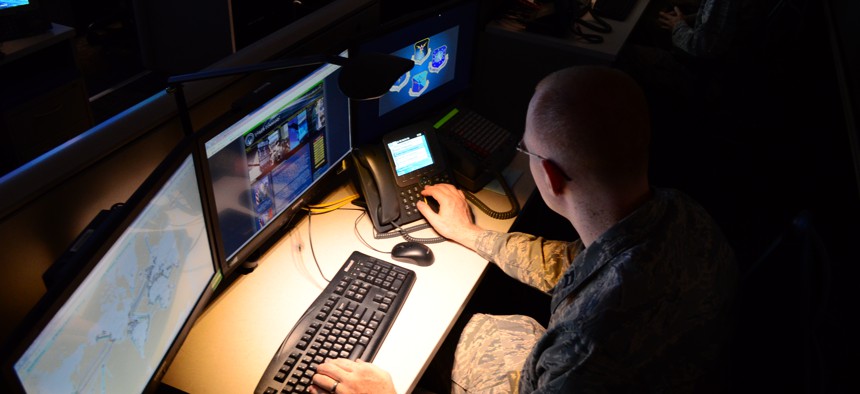 An airman at Port San Antonio goes over systems during an open house for the Air Force's cyber forces. 