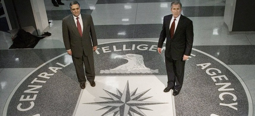 Then President George Bush (R) stands with then-CIA Director George Tenet, on March, 20, 2001. 