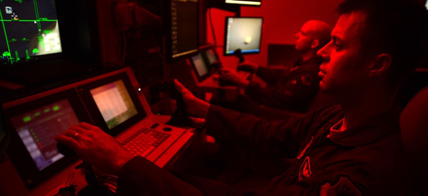 First Lt. Kyle, 91st Attack Squadron pilot, and Tech. Sgt. Jason, 91st ATKS sensor operator, fly a simulated training mission on an MQ-9 Reaper at Creech Air Force Base, Nev., May 8, 2014.