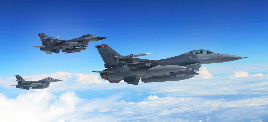 U.S. Air Force F-16 Fighting Falcons await refueling from a KC-135 Stratotanker assigned to the 351st Expeditionary Air Refueling Squadron-Poland June 13, 2014.