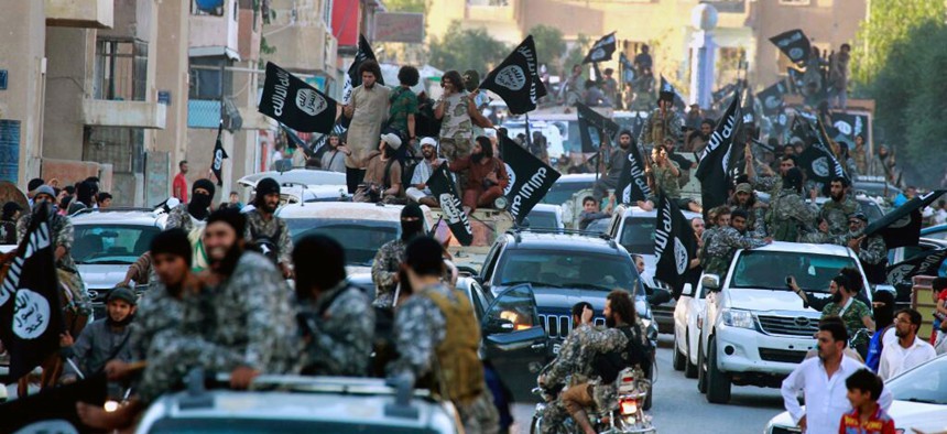 Fighters from the Islamic State group parade in Raqqa, north Syria, on June 19,2014.