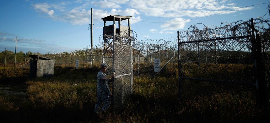 A U.S. soldier closes the gate at a now-abandoned detention facility at Naval Station Guantanamo Bay, Cuba, Nov. 13, 2013. 