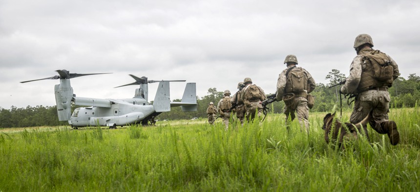 Marines with the 26th Marine Expeditionary Unit sprint to an MV-22B Osprey aircraft during a Tactical Recovery of Aircraft and Personnel exercise, aboard Camp Lejeune, North Carolina, June 5, 2015.