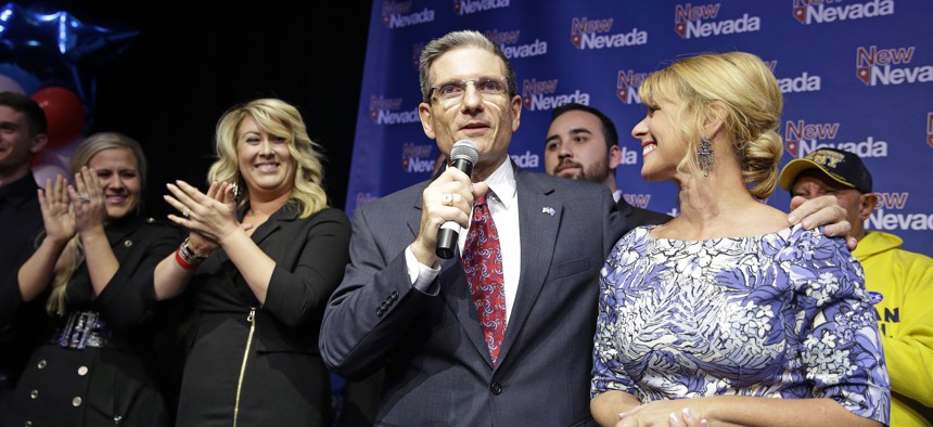 Rep. Joe Heck, R-Nev., gives a victory speech with his wife Lisa Heck, right, after defeating Erin Bilbray to keep his seat in Congress Tuesday, Nov. 4, 2014, in Las Vegas. 