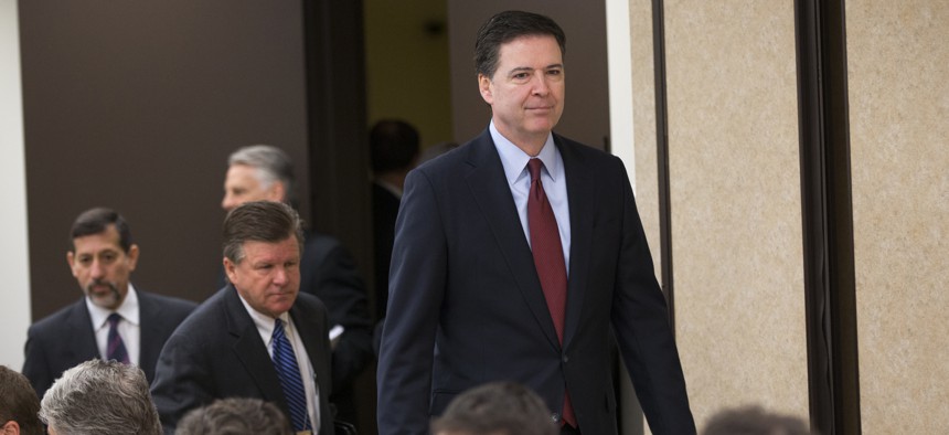 FBI director James Comey arrives for a news conference at FBI headquarters in Washington, Wednesday, March 25, 2015.