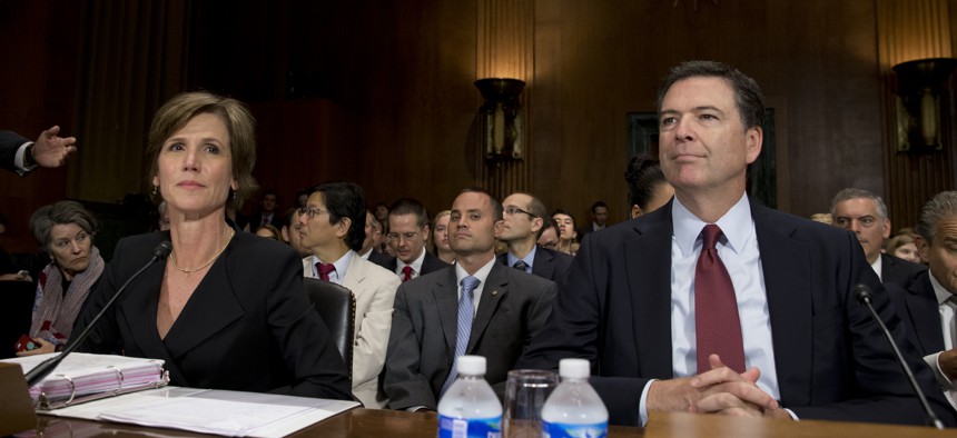 FBI Director James Comey, right, and Deputy Attorney General Sally Quillian Yates, are seated as they arrive to testify at the Senate Judiciary Committee hearing on Capitol Hill in Washington, Wednesday, July 8, 2015.