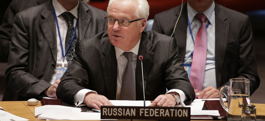 Russian permanent resident to the United Nations, Vitaly Churkin, center, speaks to the U.N. Security Council, Friday, Sept. 19, 2014.