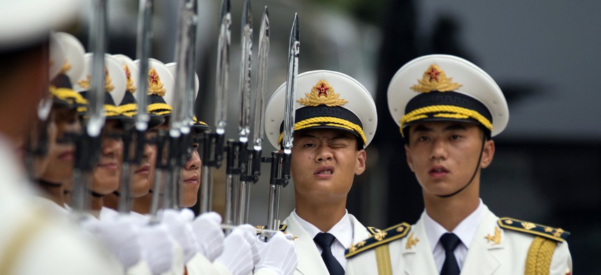 Members of a Chinese honor guard prepare for a welcome ceremony for the Belgium King in Beijing, Tuesday, June 23, 2015.